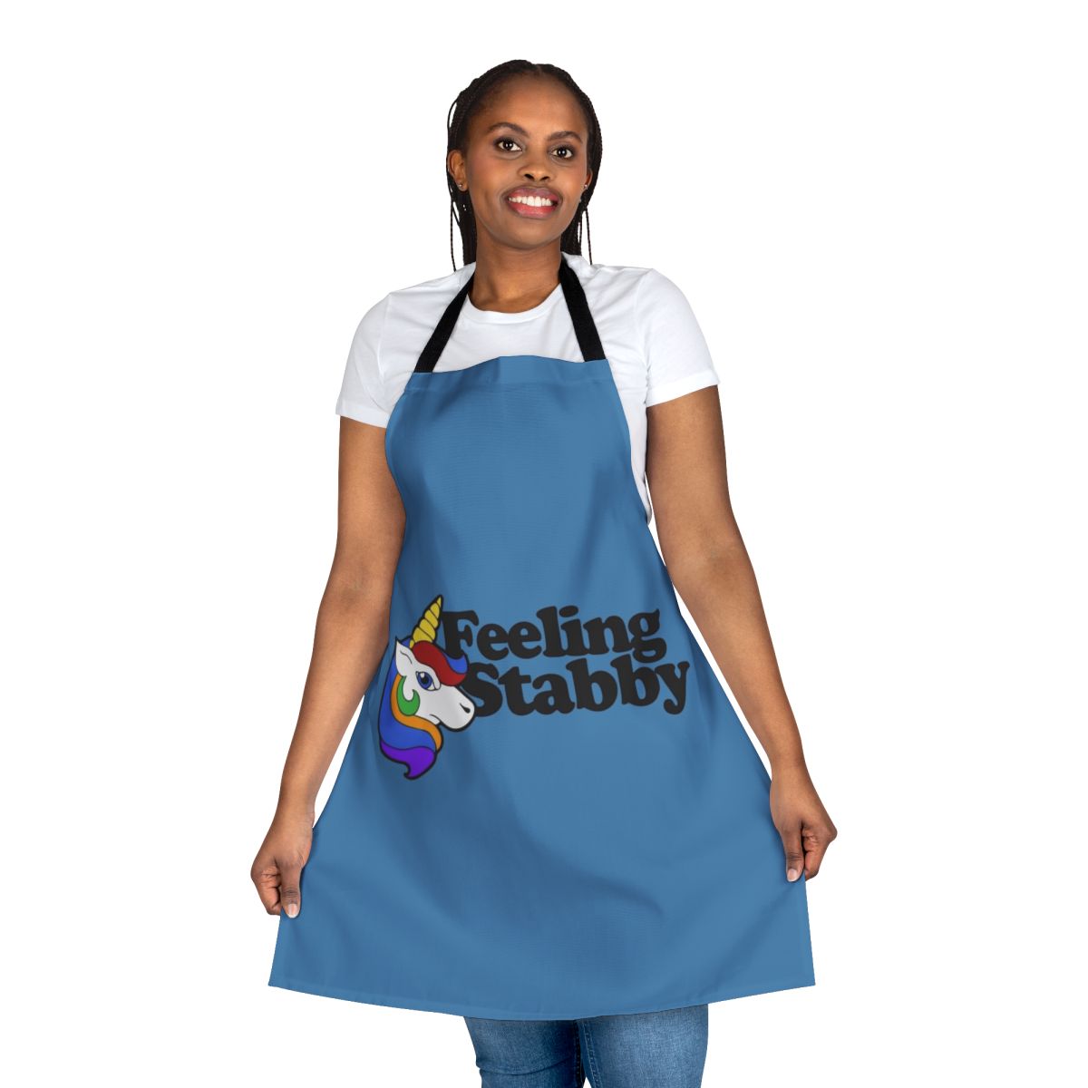 A white apron with a "Feeling Stabby" unicorn design, a humorous and quirky kitchen accessory.