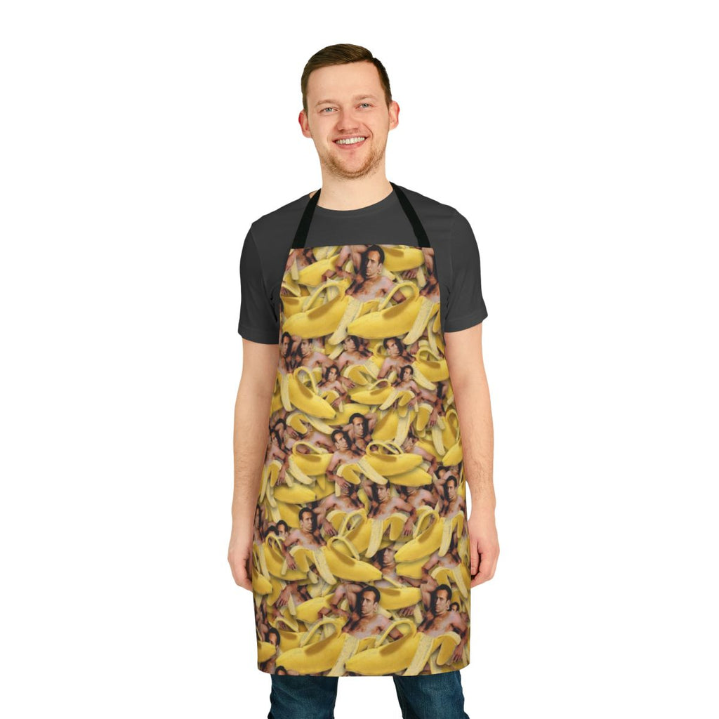 A quirky apron featuring a collage of Nicolas Cage's face on a yellow banana pattern.