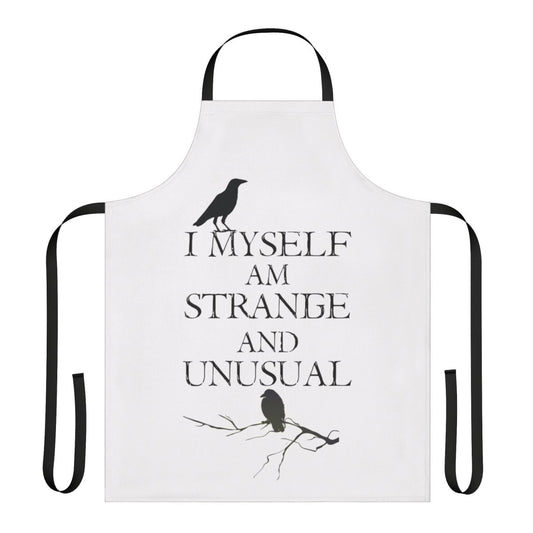 A black and white apron featuring the quote "I Myself Am Strange and Unusual" from the classic Tim Burton film Beetlejuice.