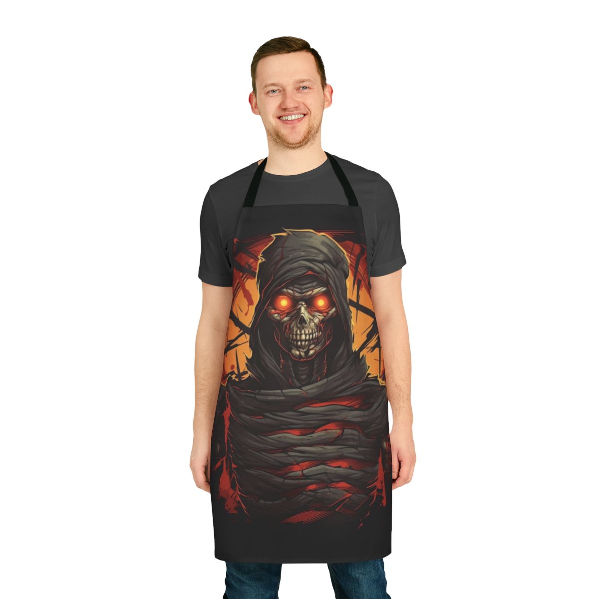 Dark apron with creepy mummy design, featuring glowing red eyes and sharp decayed teeth.