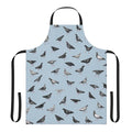 An apron featuring a pattern of grey pigeons or doves in an urban setting.