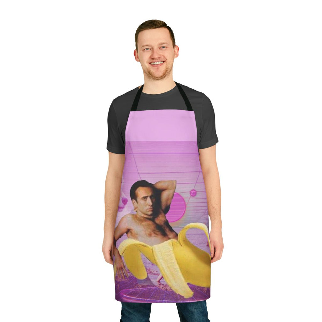 A vibrant and whimsical apron featuring a playful design of Nicholas Cage's face and bananas against a vaporwave-inspired background.