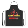 Vegan bodybuilder wearing a black apron with the text "Vegan Gorilla Badass Bodybuilder" printed on it.