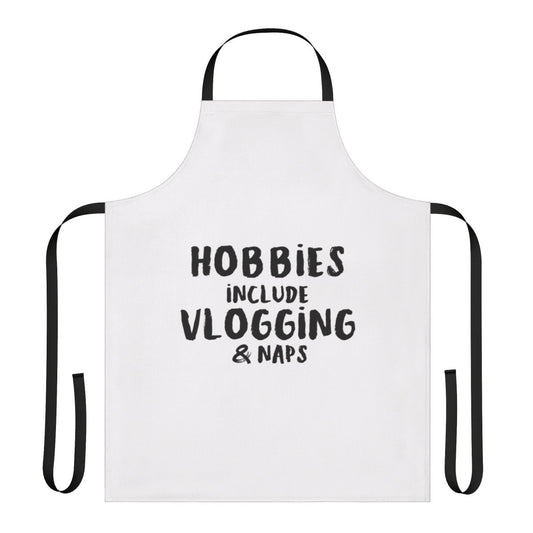 A stylish and functional apron featuring the text "Hobbies Include Vlogging And Napping"