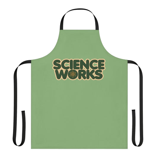 Person wearing a white science-themed apron with various scientific icons and designs