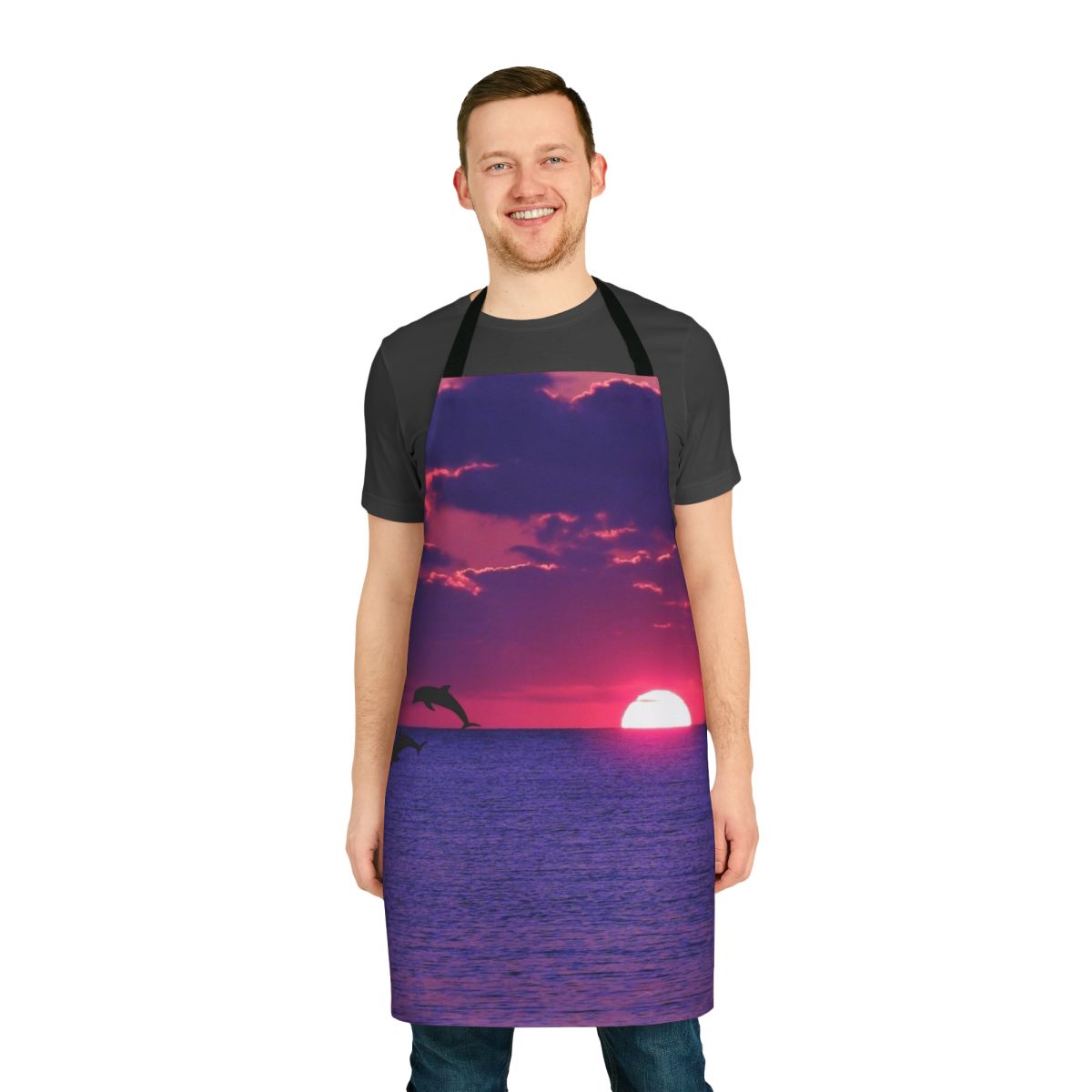 Apron with a beautiful, colorful beach sunset scene featuring a pink and purple sky, ocean horizon, and dolphin silhouette