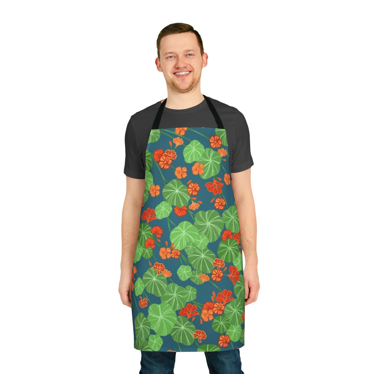 Closeup of a floral apron with a vibrant orange, green, and blue nasturtium pattern