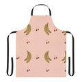 A pink apron with a cherry and banana pattern, perfect for the kitchen