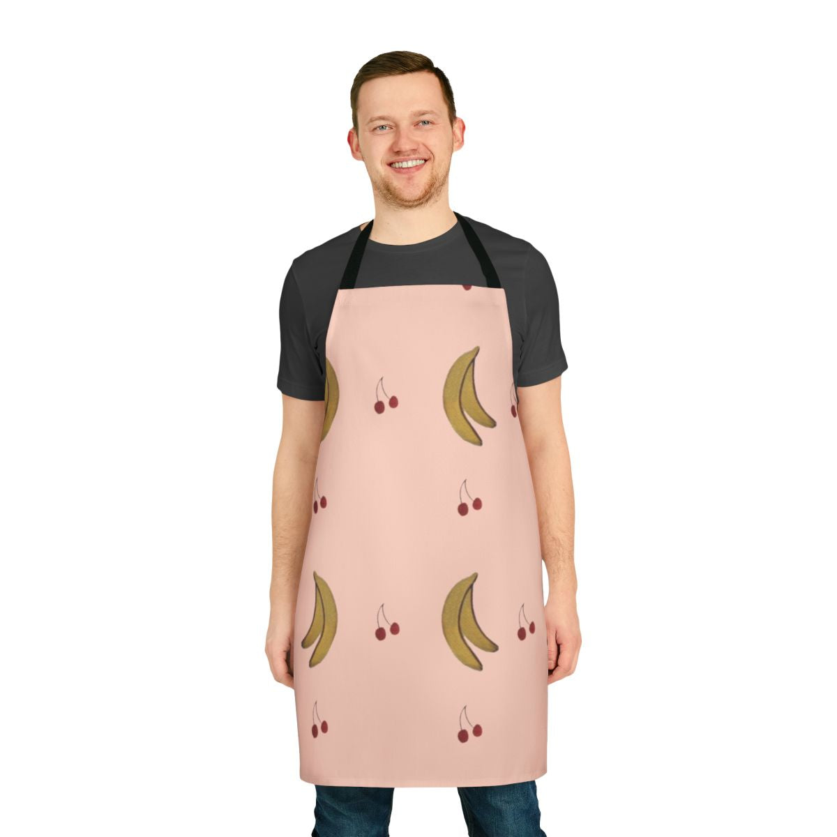 A pink apron with a cherry and banana pattern, perfect for the kitchen