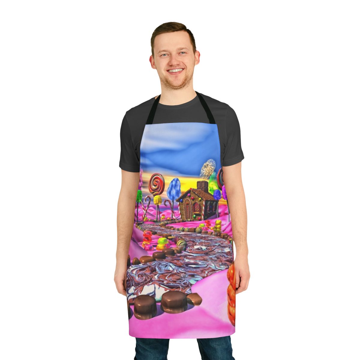 Colorful pink apron with candyland-inspired design featuring candy, gingerbread, and sweet treats