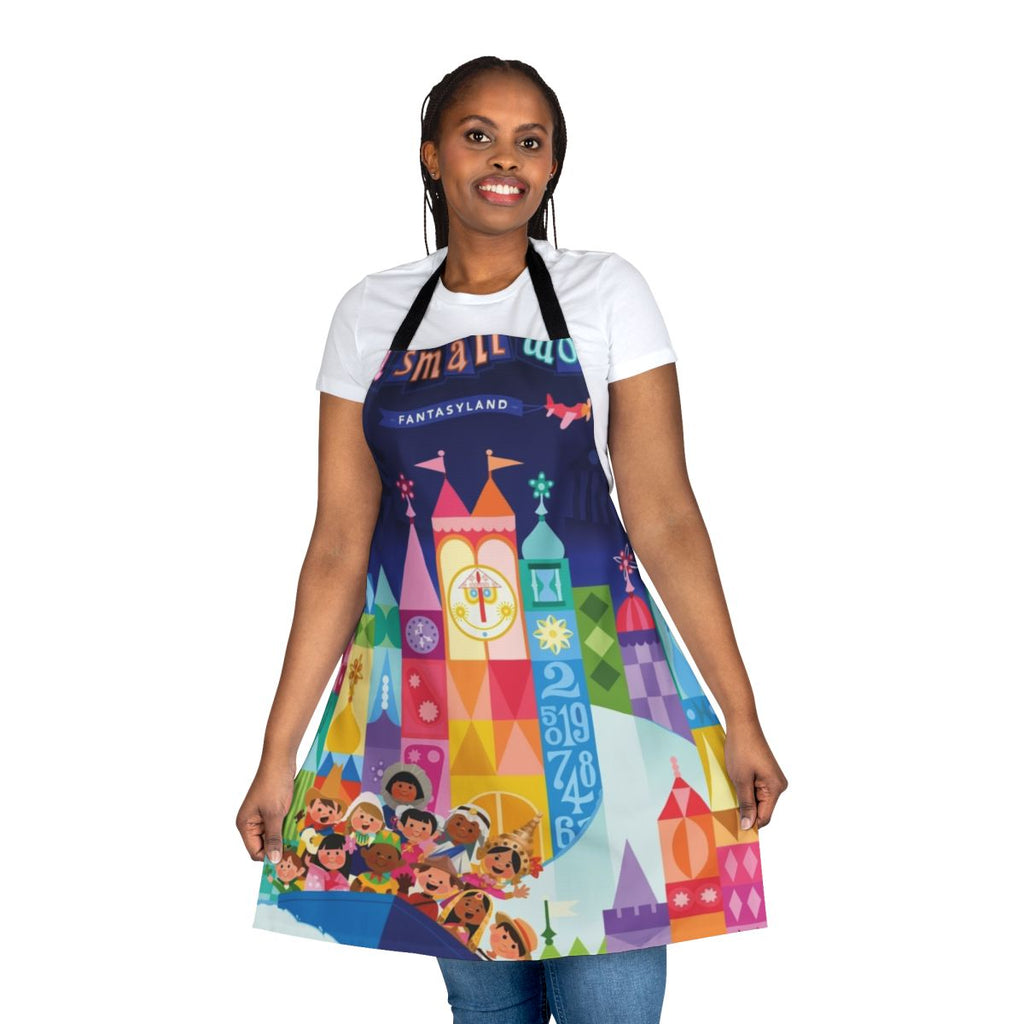 Colorful illustrated apron featuring a fantasy world with boats, cities, and whimsical elements.
