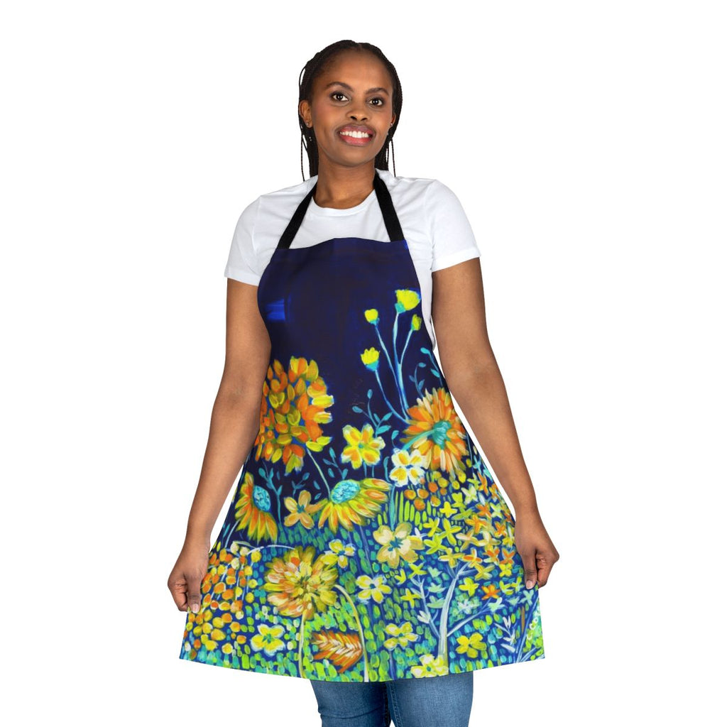 A colorful floral apron in shades of blue, yellow, and white featuring daisies and other botanical designs.