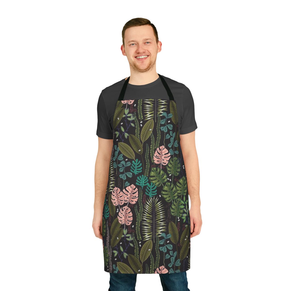 Lush, tropical-inspired apron featuring monstera leaves, palm fronds, and a blend of green, pink, and black