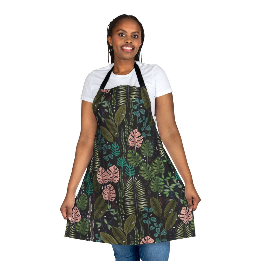 Lush, tropical-inspired apron featuring monstera leaves, palm fronds, and a blend of green, pink, and black