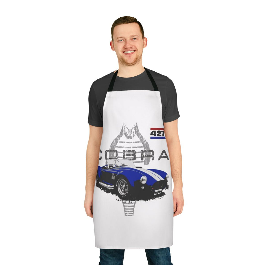 Vintage car enthusiast wearing a retro-styled apron with an AC Cobra graphic