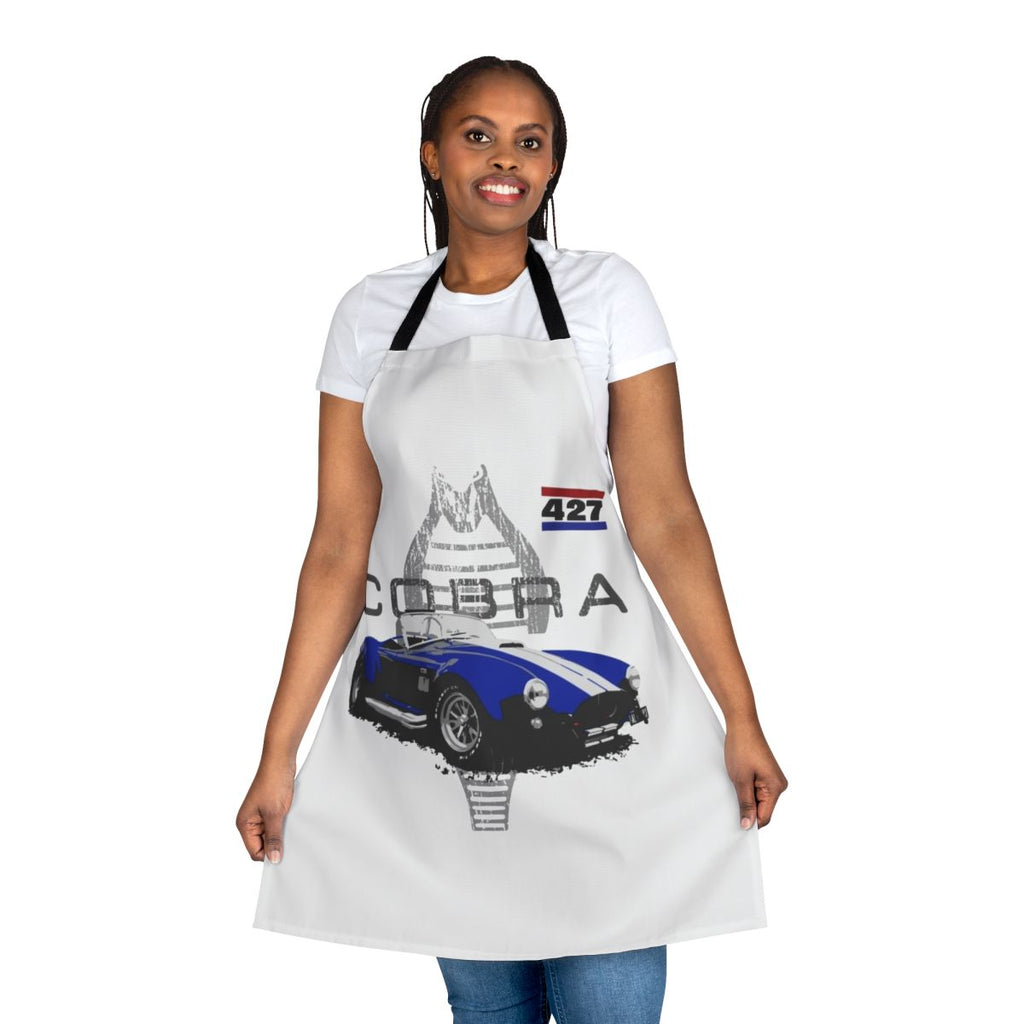 Vintage car enthusiast wearing a retro-styled apron with an AC Cobra graphic