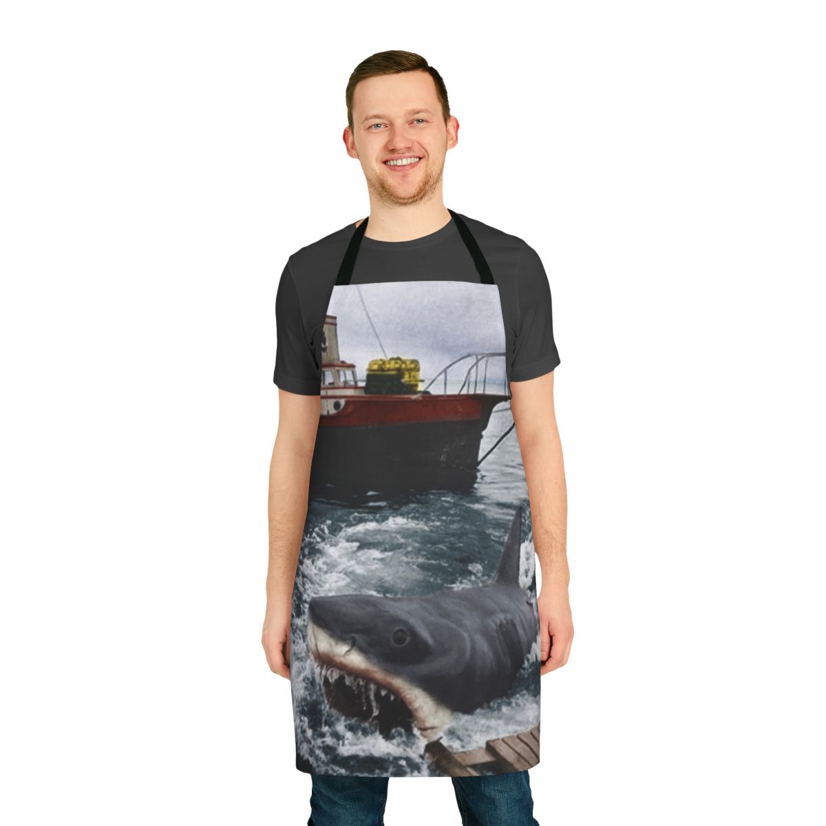 A vintage-style apron featuring the iconic Jaws movie poster design, perfect for photography, cooking, and baking enthusiasts.