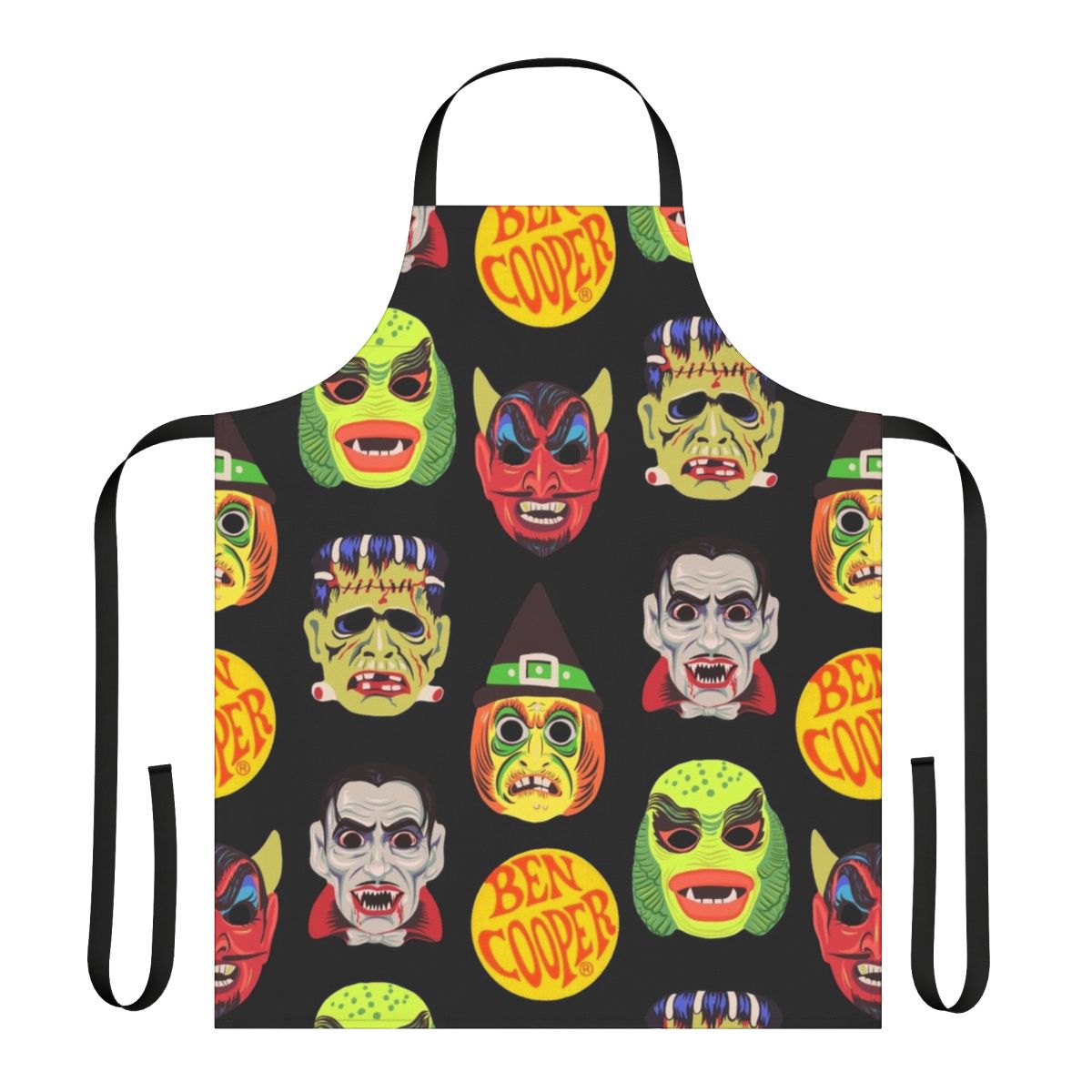 Vintage-style apron featuring classic Halloween monster masks like Dracula, Frankenstein, and the Creature from the Black Lagoon