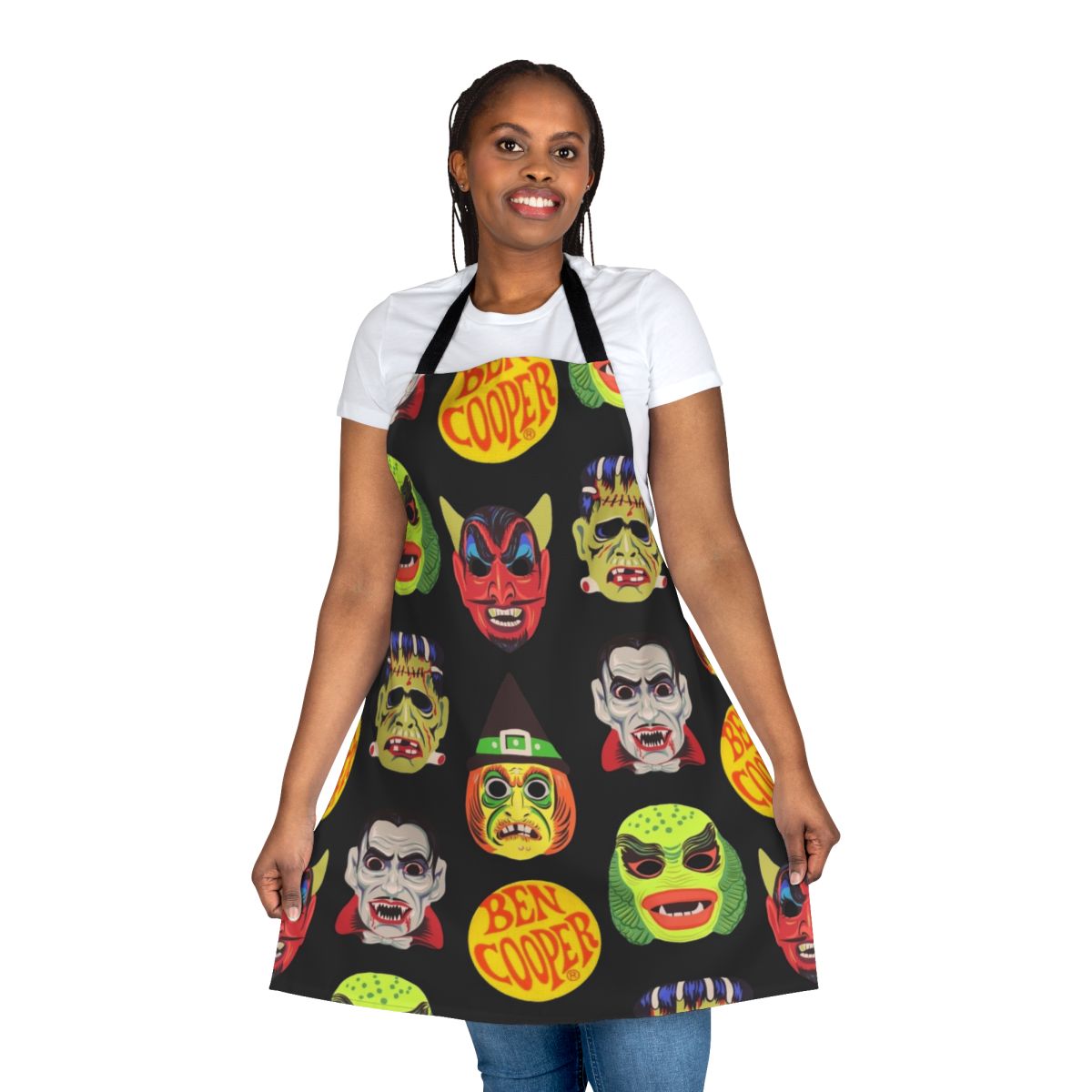 Vintage-style apron featuring classic Halloween monster masks like Dracula, Frankenstein, and the Creature from the Black Lagoon
