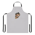 Whimsical apron with a mischievous cat peeking out from a ripped or torn paper/wall design