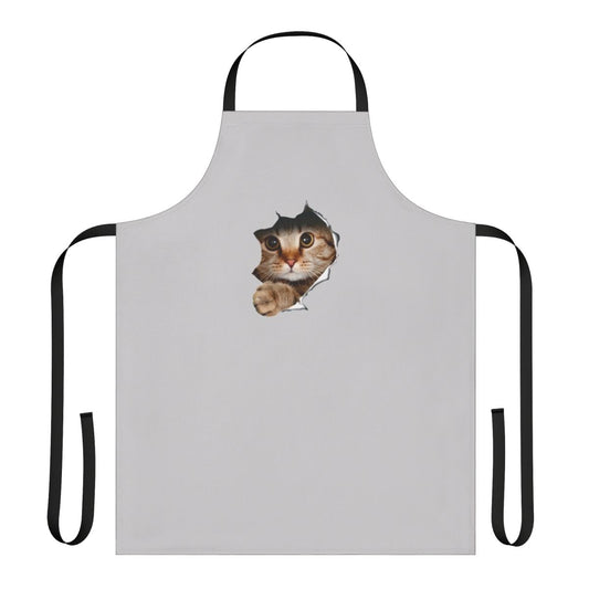 Whimsical apron with a mischievous cat peeking out from a ripped or torn paper/wall design