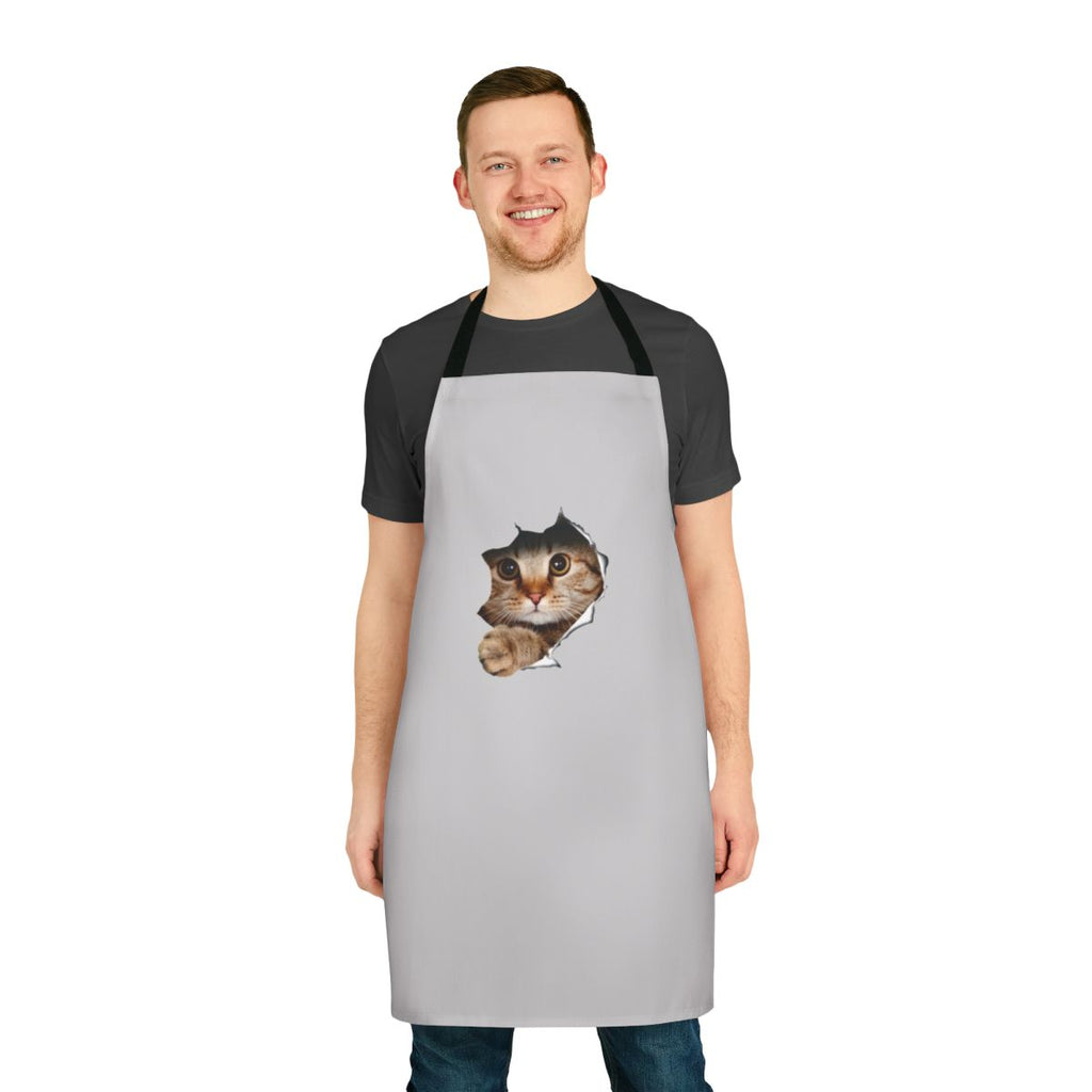 Whimsical apron with a mischievous cat peeking out from a ripped or torn paper/wall design