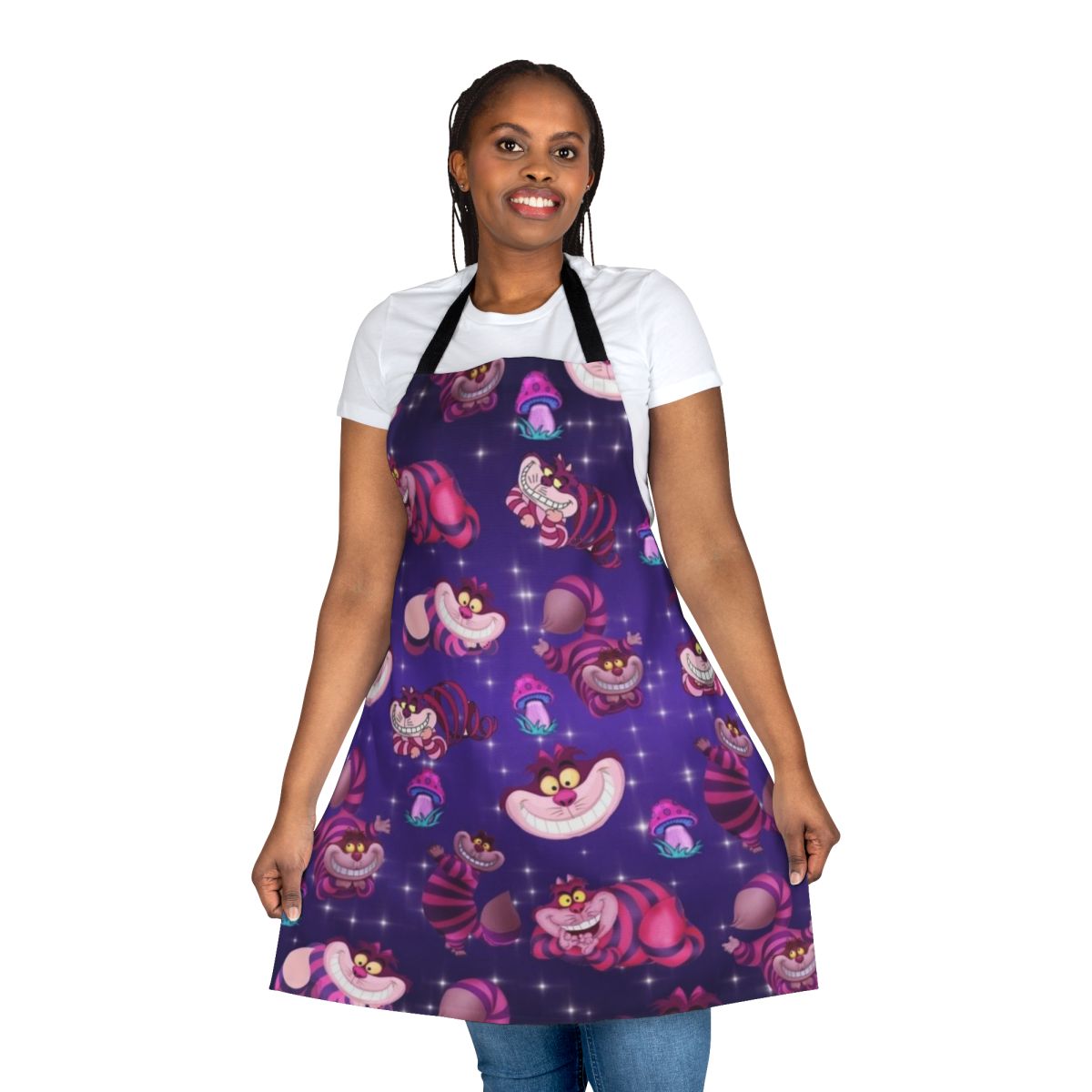 A colorful apron featuring a whimsical Alice in Wonderland-inspired design with a cat, mushrooms, and the Cheshire Cat.