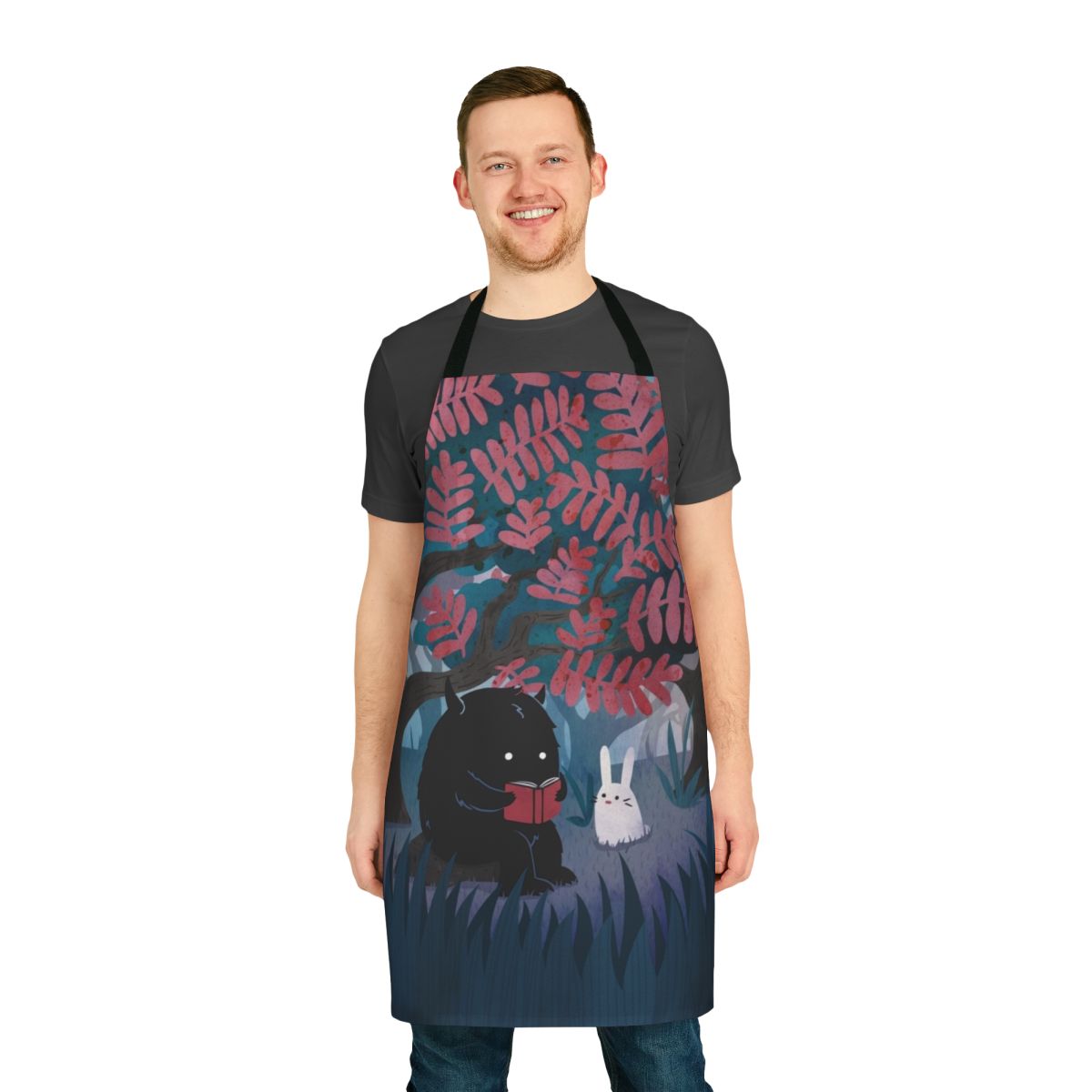 Apron featuring a watercolor design of forest friends, including a monster, bunny, and other woodland creatures, perfect for bookish nature lovers.