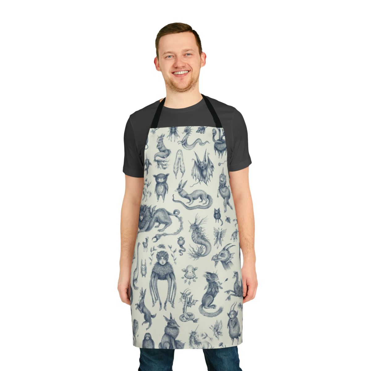 Apron featuring a pastel pattern with various magical and mythological creatures like Bigfoot, Loch Ness Monster, and dragons.