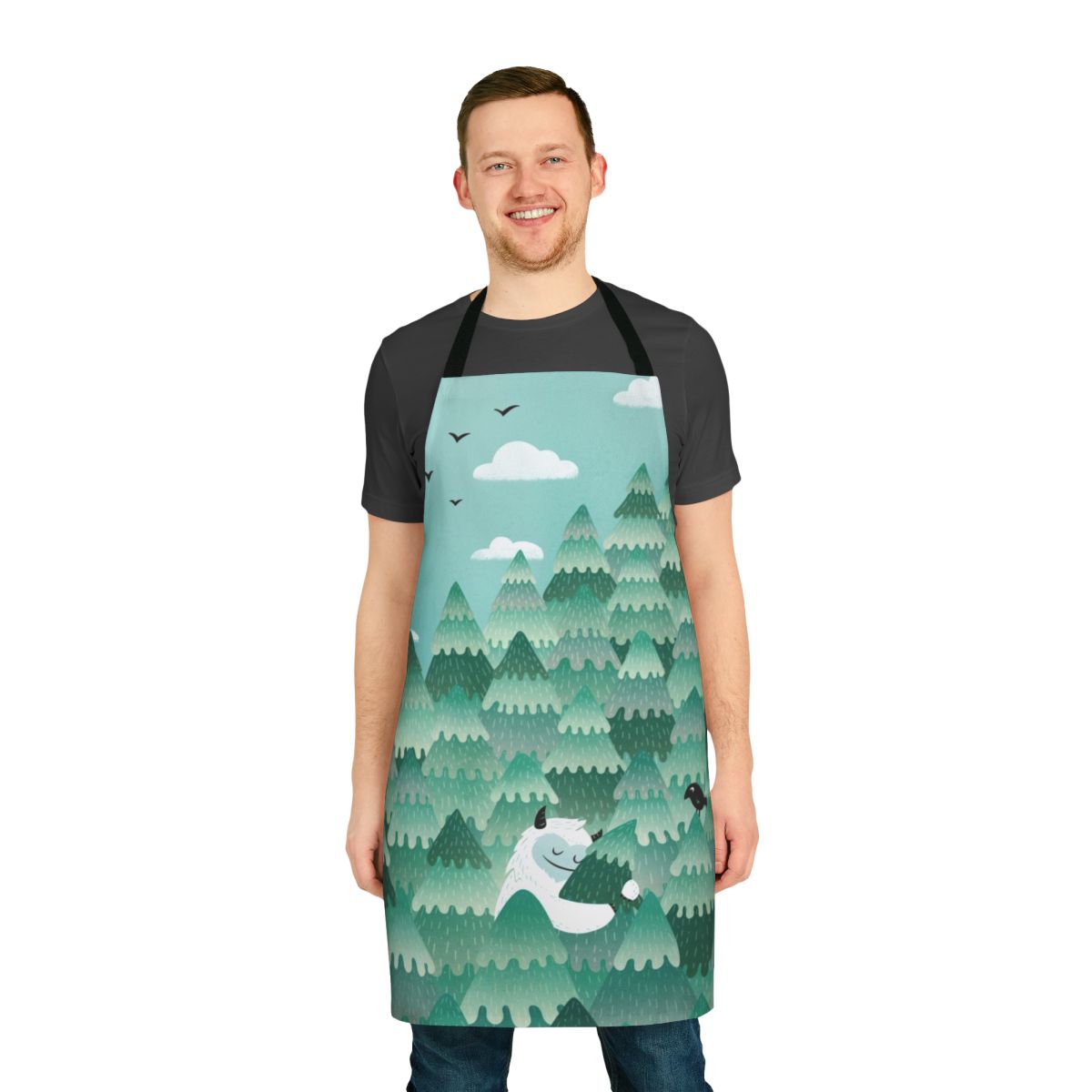 A colorful apron design featuring a forest monster or Bigfoot-like creature embracing a tree in a spring or summer forest scene.