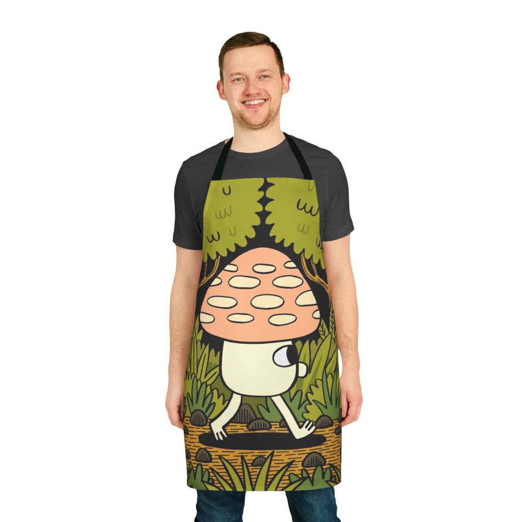 A whimsical apron featuring a woodland scene with mushrooms, leaves, and ferns in shades of green and yellow.